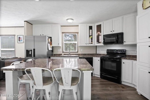288 Forks Grove Rd, Lafollette, TN 37766 - kitchen featuring black appliances, white cabinets, glass insert cabinets, dark stone countertops, and a textured ceiling