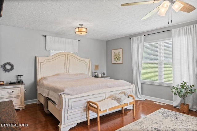 288 Forks Grove Rd, Lafollette, TN 37766 - bedroom featuring dark wood-style flooring, a textured ceiling, and a ceiling fan