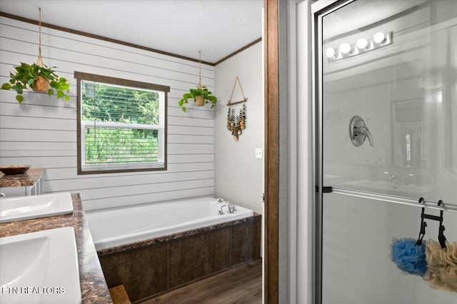 288 Forks Grove Rd, Lafollette, TN 37766 - bathroom with wood finished floors, double vanity, a bath, ornamental molding, and a stall shower
