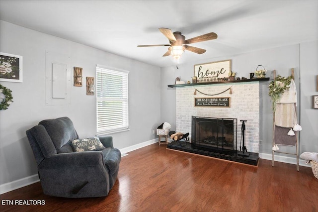288 Forks Grove Rd, Lafollette, TN 37766 - living area featuring a brick fireplace, wood finished floors, a ceiling fan, and electric panel