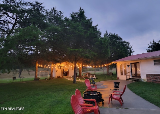288 Forks Grove Rd, Lafollette, TN 37766 - view of grassy yard featuring a fire pit, a patio area, and french doors