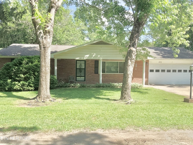 195 Hamblin St, New Tazewell, TN 37825 - view of front of home featuring an attached garage, brick siding, a front lawn, and driveway