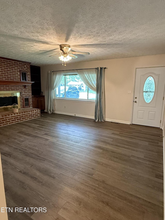 195 Hamblin St, New Tazewell, TN 37825 - unfurnished living room with a ceiling fan, a textured ceiling, dark wood-type flooring, and a fireplace