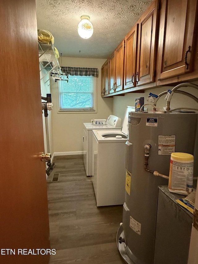 195 Hamblin St, New Tazewell, TN 37825 - laundry area with cabinet space, water heater, independent washer and dryer, dark wood-style flooring, and a textured ceiling