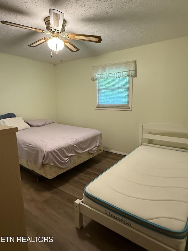 195 Hamblin St, New Tazewell, TN 37825 - bedroom with wood finished floors, a textured ceiling, and a ceiling fan