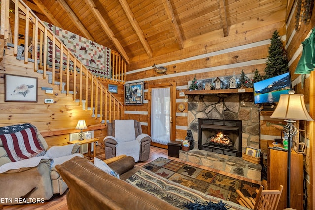2784 Mountain View Cir, Sevierville, TN 37862 - living area with wooden ceiling, wood finished floors, wooden walls, a stone fireplace, and stairs