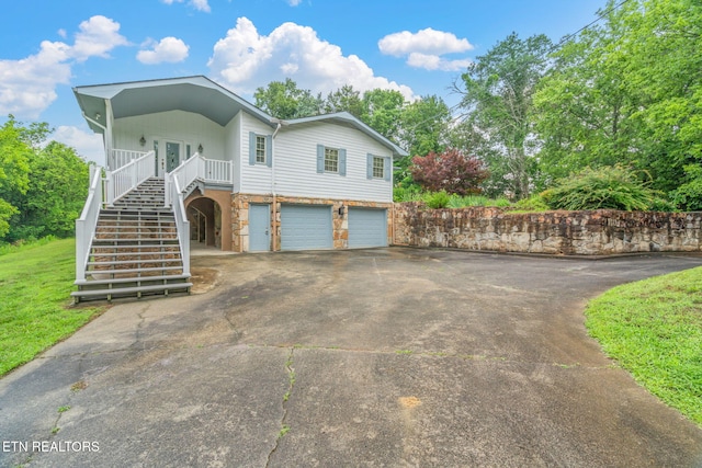 363 Staghorn Ln, Seymour, TN 37865 - view of front of home with stairway, stone siding, asphalt driveway, and a garage