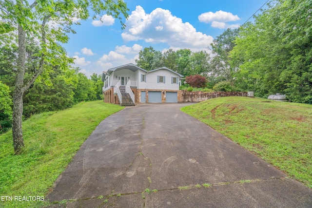 363 Staghorn Ln, Seymour, TN 37865 - view of front of home featuring stairway, an attached garage, driveway, a front lawn, and covered porch