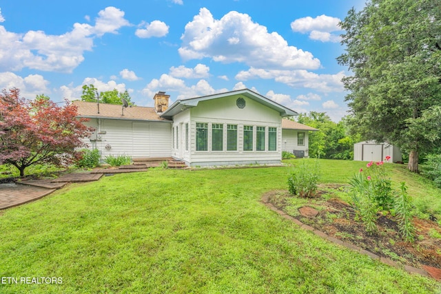 363 Staghorn Ln, Seymour, TN 37865 - rear view of house with a storage shed, a yard, and a chimney