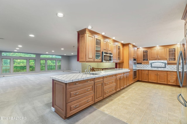 363 Staghorn Ln, Seymour, TN 37865 - kitchen with appliances with stainless steel finishes, recessed lighting, brown cabinetry, tile countertops, and decorative backsplash