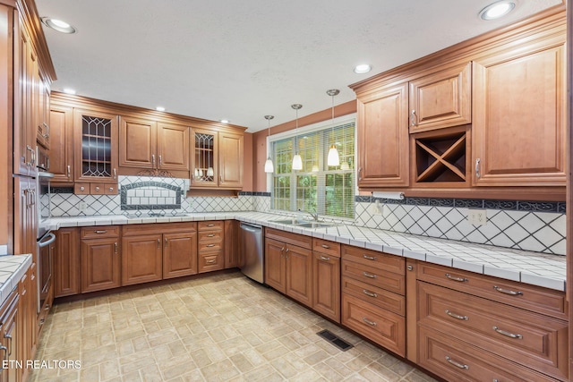 363 Staghorn Ln, Seymour, TN 37865 - kitchen with stainless steel appliances, brown cabinetry, hanging light fixtures, glass insert cabinets, and recessed lighting