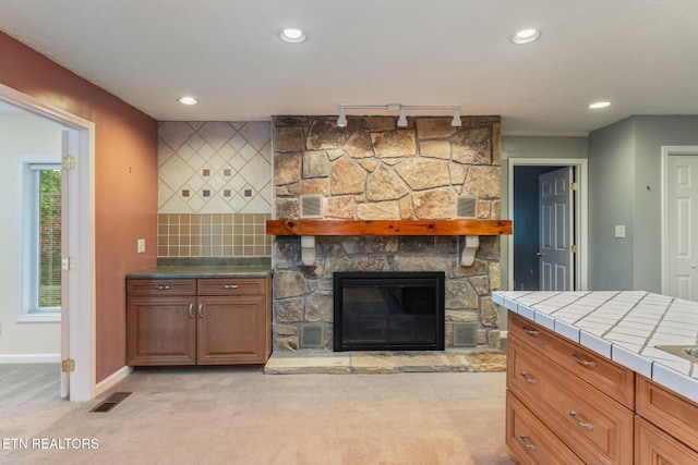 363 Staghorn Ln, Seymour, TN 37865 - living room featuring light colored carpet, recessed lighting, rail lighting, and a stone fireplace