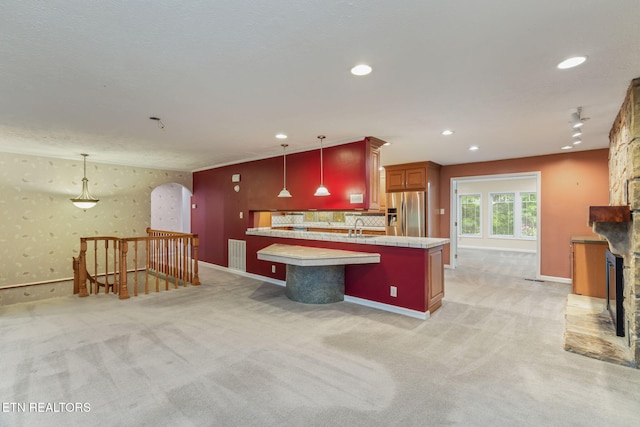 363 Staghorn Ln, Seymour, TN 37865 - kitchen with stainless steel fridge, light carpet, a fireplace, recessed lighting, and decorative light fixtures
