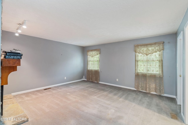 363 Staghorn Ln, Seymour, TN 37865 - empty room featuring carpet flooring, track lighting, and a textured ceiling