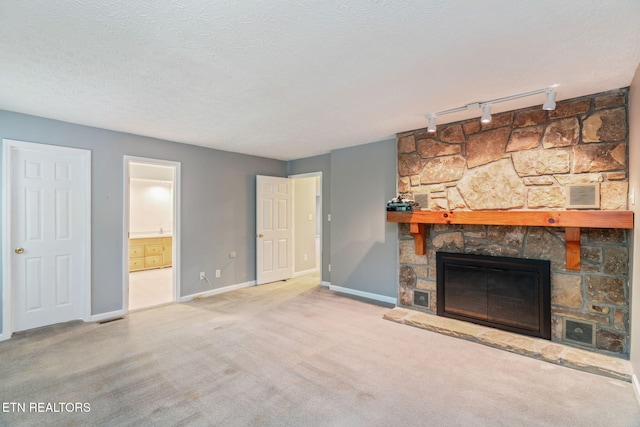363 Staghorn Ln, Seymour, TN 37865 - unfurnished living room featuring track lighting, a fireplace, carpet flooring, and a textured ceiling