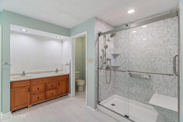 363 Staghorn Ln, Seymour, TN 37865 - bathroom with a shower stall, double vanity, and a textured ceiling