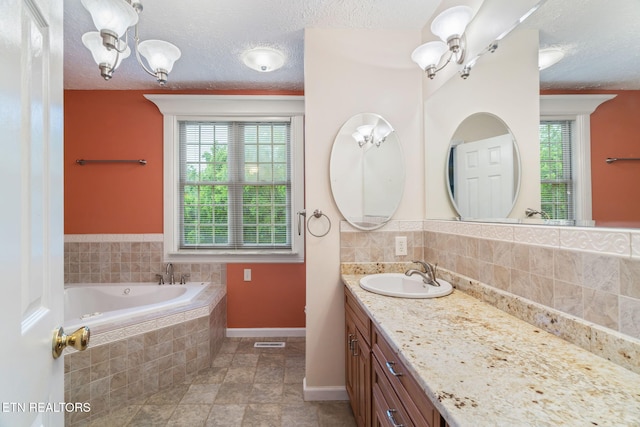 363 Staghorn Ln, Seymour, TN 37865 - bathroom featuring a chandelier, vanity, a bath, a textured ceiling, and decorative backsplash