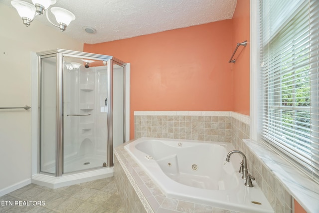 363 Staghorn Ln, Seymour, TN 37865 - full bathroom featuring a stall shower, a tub with jets, a textured ceiling, and a chandelier