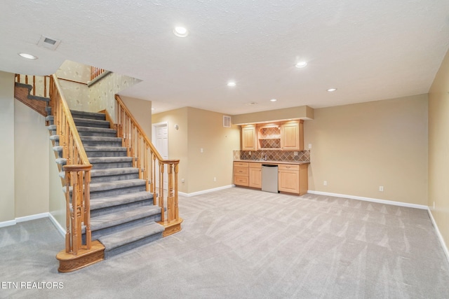 363 Staghorn Ln, Seymour, TN 37865 - unfurnished living room featuring light colored carpet, stairs, wet bar, and recessed lighting