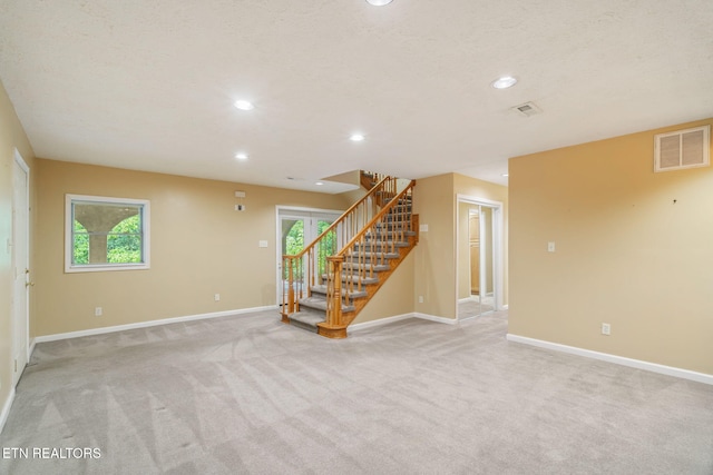 363 Staghorn Ln, Seymour, TN 37865 - unfurnished living room with light carpet, stairway, and recessed lighting