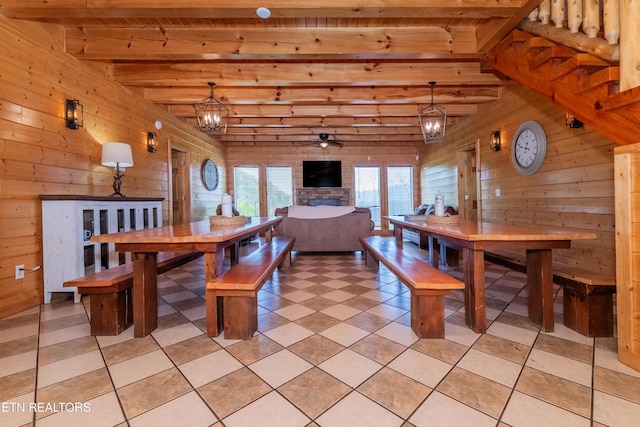 1032 Black Bear Cub Way, Sevierville, TN 37862 - dining space with wooden walls, a chandelier, light tile patterned floors, a wood ceiling with exposed beams, and ceiling fan