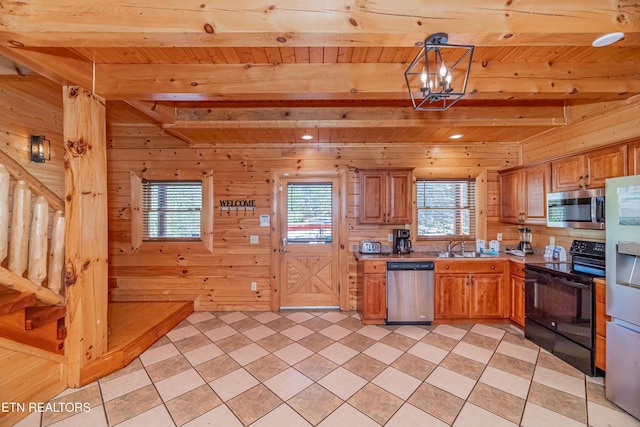 1032 Black Bear Cub Way, Sevierville, TN 37862 - kitchen featuring stainless steel appliances, a wooden ceiling with exposed beams, plenty of natural light, wood walls, and light countertops