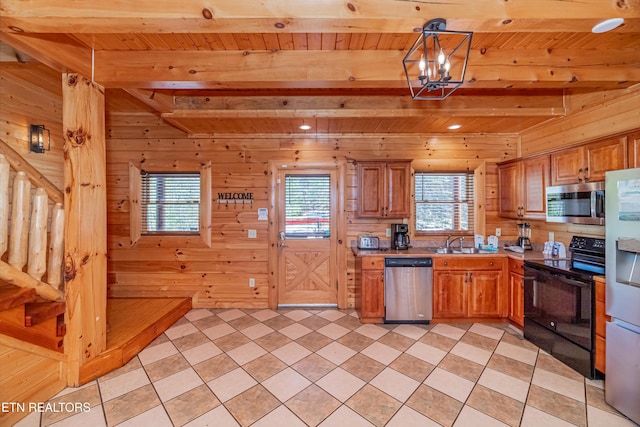 1032 Black Bear Cub Way, Sevierville, TN 37862 - kitchen featuring appliances with stainless steel finishes, a wood ceiling with exposed beams, plenty of natural light, light countertops, and wood walls
