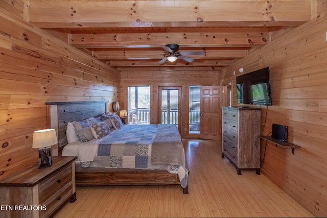 1032 Black Bear Cub Way, Sevierville, TN 37862 - bedroom with wooden walls, beamed ceiling, light wood-style flooring, and access to exterior