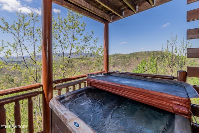1032 Black Bear Cub Way, Sevierville, TN 37862 - wooden deck featuring a hot tub and a view of trees