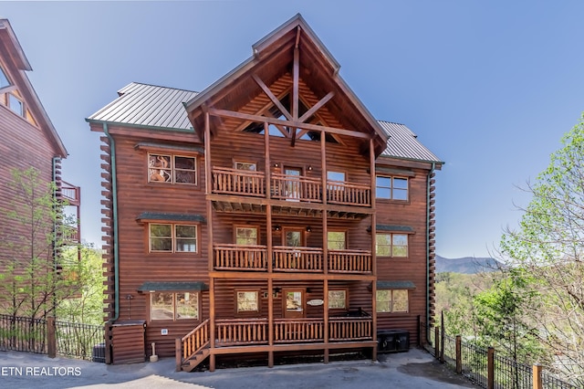 1032 Black Bear Cub Way, Sevierville, TN 37862 - back of property with a balcony, log siding, a standing seam roof, a metal roof, and a mountain view
