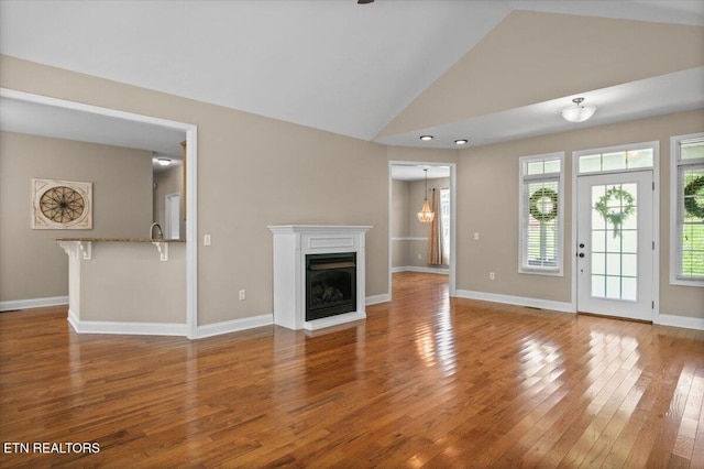 171 Forest Cove Ct, Jacksboro, TN 37757 - unfurnished living room featuring a fireplace, wood finished floors, and high vaulted ceiling