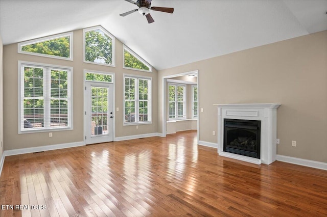 171 Forest Cove Ct, Jacksboro, TN 37757 - unfurnished living room featuring ceiling fan, a fireplace, wood finished floors, and high vaulted ceiling