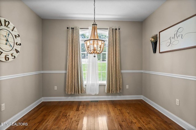 171 Forest Cove Ct, Jacksboro, TN 37757 - unfurnished dining area featuring a chandelier and dark wood finished floors