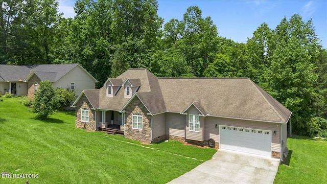 171 Forest Cove Ct, Jacksboro, TN 37757 - view of front of property featuring stone siding, an attached garage, concrete driveway, and a front yard