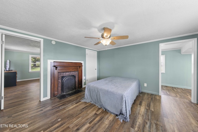 204 Queener St, Jacksboro, TN 37757 - bedroom with wood finished floors, ornamental molding, a fireplace, a textured ceiling, and a ceiling fan