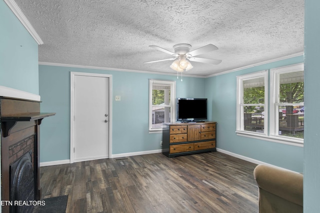 204 Queener St, Jacksboro, TN 37757 - living room featuring wood finished floors, a ceiling fan, ornamental molding, a textured ceiling, and a brick fireplace