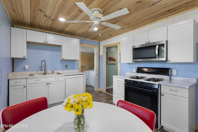 204 Queener St, Jacksboro, TN 37757 - kitchen featuring stainless steel microwave, range with gas stovetop, white dishwasher, wood ceiling, and washing machine and dryer