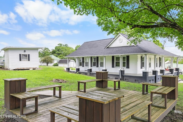 204 Queener St, Jacksboro, TN 37757 - wooden porch featuring a lawn, an outdoor structure, and an outdoor fire pit