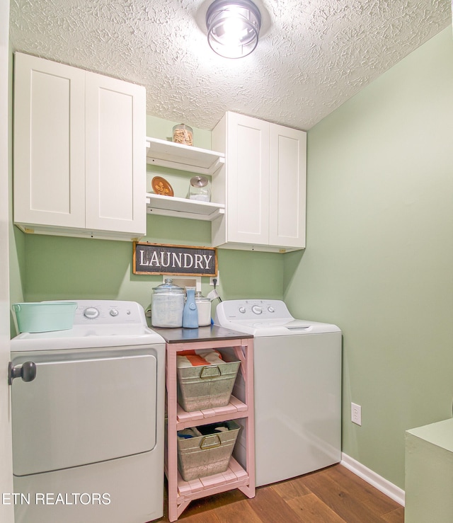 181 Overlook Ln, Jacksboro, TN 37757 - laundry room with cabinet space, washer and dryer, wood finished floors, and a textured ceiling