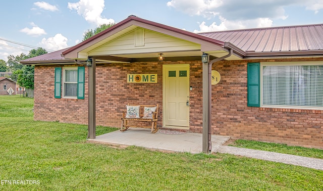 181 Overlook Ln, Jacksboro, TN 37757 - view of exterior entry featuring a lawn and a metal roof