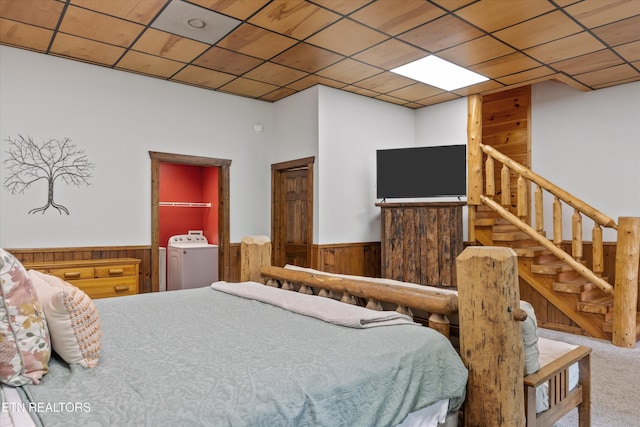 1235 Honeysuckle Ln, Sevierville, TN 37876 - bedroom with washer / clothes dryer, carpet floors, wainscoting, and wooden walls