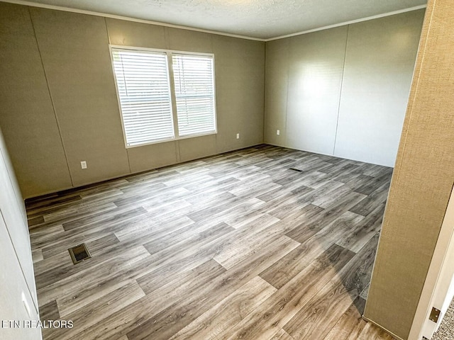 338 Bungalow Dr, Dandridge, TN 37725 - empty room featuring wood finished floors, crown molding, and a textured ceiling