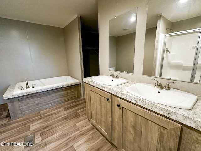 338 Bungalow Dr, Dandridge, TN 37725 - full bathroom with a garden tub, a shower stall, double vanity, and wood finished floors