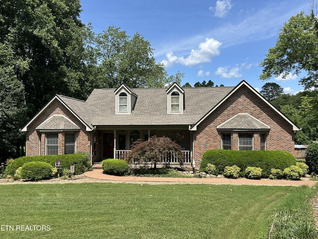302 Lake St, Harriman, TN 37748 - cape cod-style house with brick siding, a porch, a front lawn, and a shingled roof