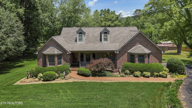 302 Lake St, Harriman, TN 37748 - cape cod-style house with a porch, brick siding, a front lawn, and roof with shingles