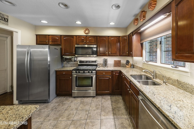 302 Lake St, Harriman, TN 37748 - kitchen with appliances with stainless steel finishes, light stone counters, light tile patterned flooring, recessed lighting, and dark brown cabinetry