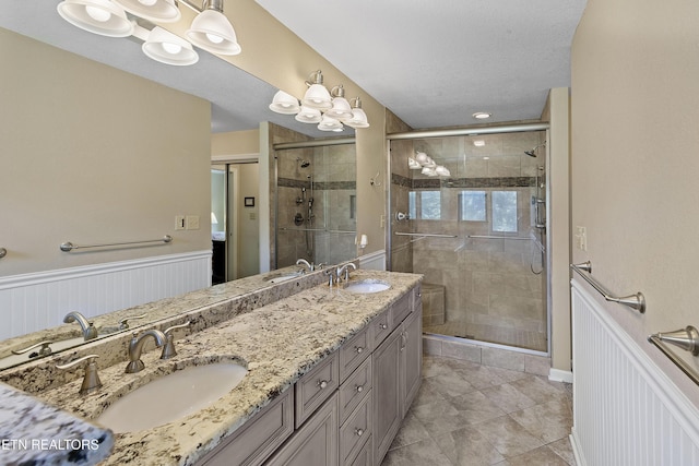 302 Lake St, Harriman, TN 37748 - bathroom featuring a stall shower, double vanity, a wainscoted wall, and tile patterned flooring