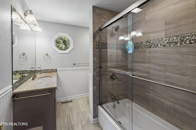 302 Lake St, Harriman, TN 37748 - full bathroom featuring combined bath / shower with glass door, vanity, a chandelier, and a wainscoted wall