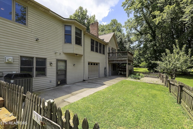 302 Lake St, Harriman, TN 37748 - back of house featuring a chimney, a deck, an attached garage, a patio, and driveway