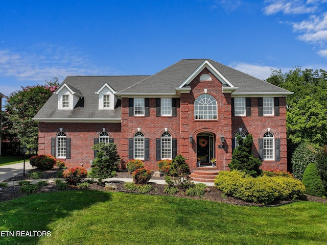 112 Reed Cir, Johnson City, TN 37601 - colonial house featuring a front yard, brick siding, and roof with shingles